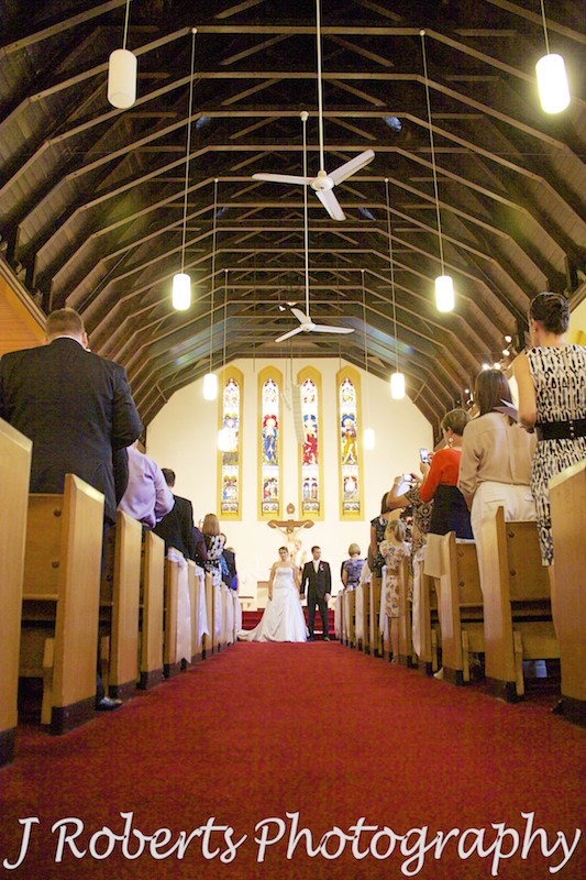 Looking down the aisle of St Francis Xavier Church Lavender Bay - wedding photography sydney